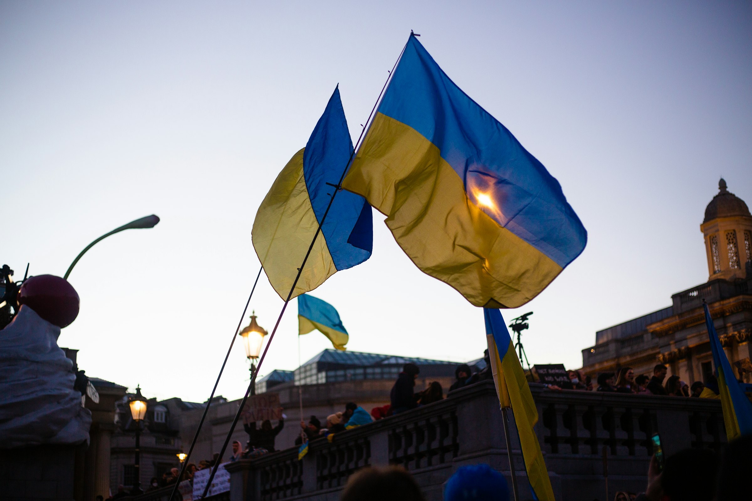 People holding Ukrainian flags in solidarity